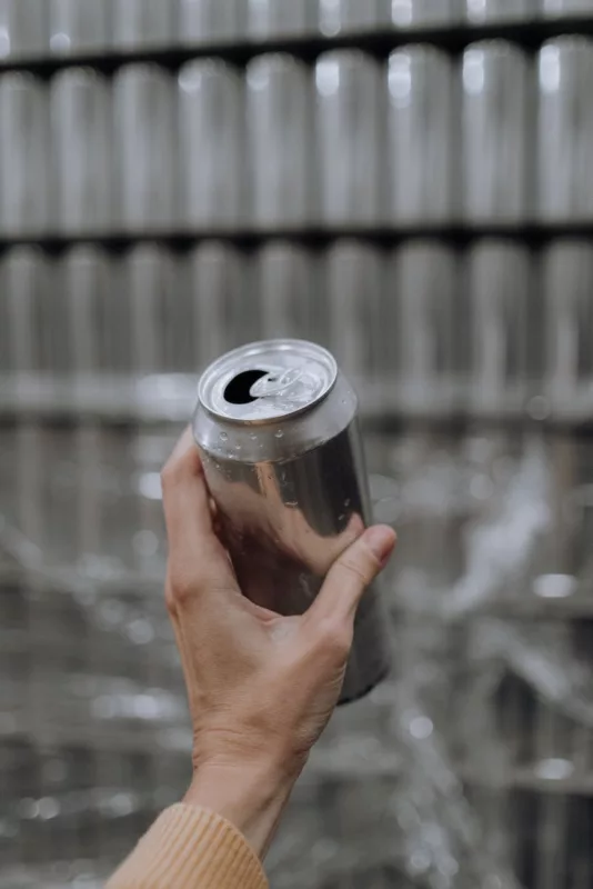 person holding a beer can